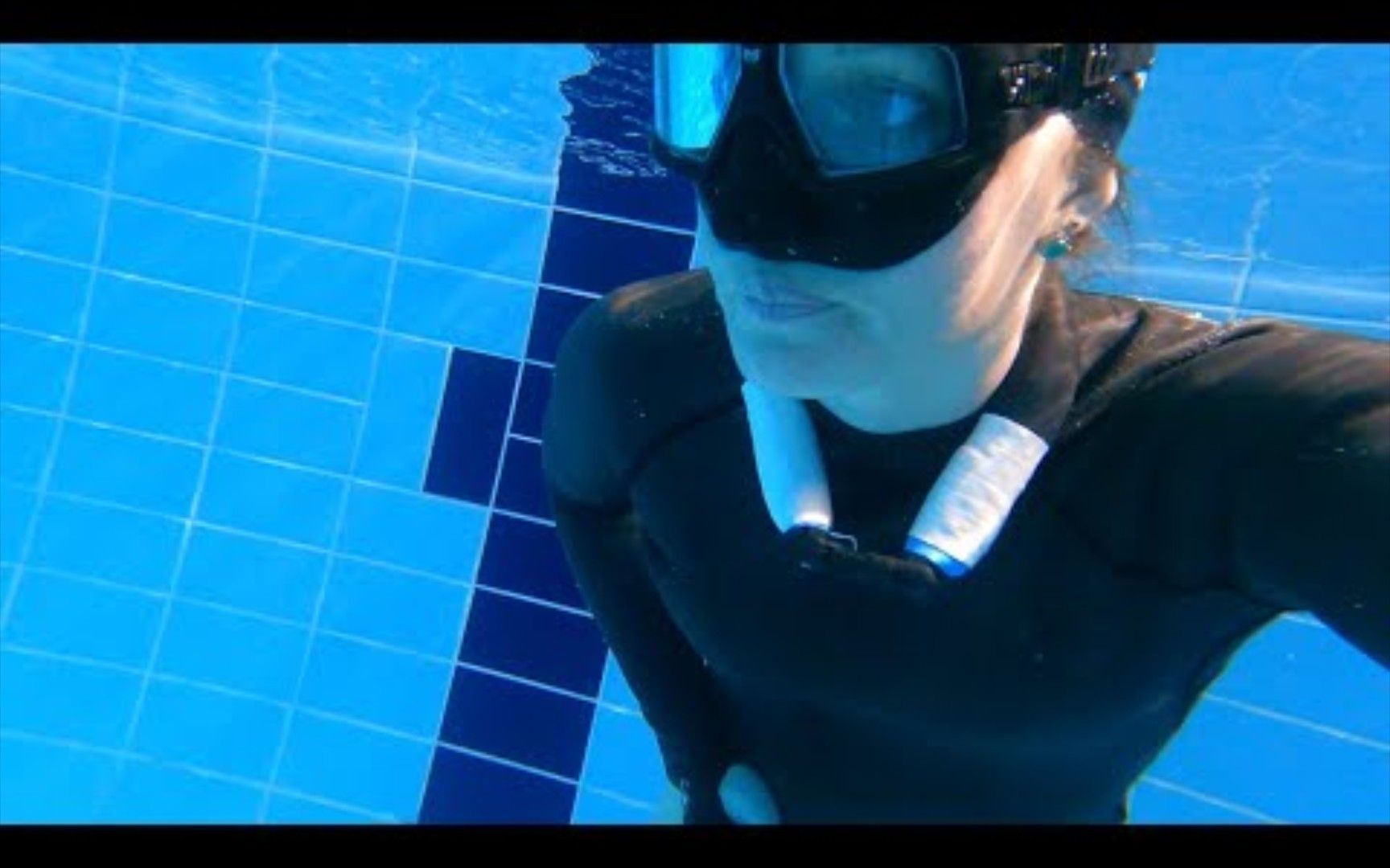 50 meters in one breath. The girl dives in the pool